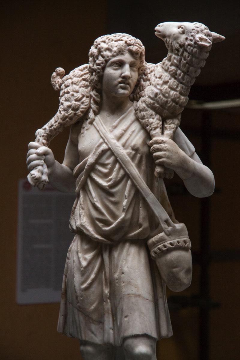 A shepherd statue among the early Christian tombs