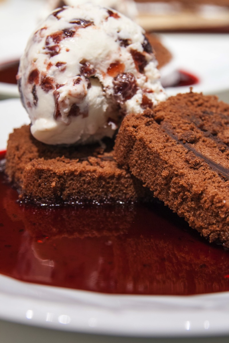 Chocolate cake with raspberry ice cream and sauce